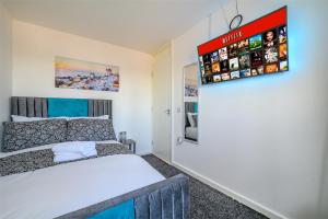 a bedroom with a bed and a sign on the wall at -RAGS- For your relaxed, Cosy Stay, Free Parking in Leeds