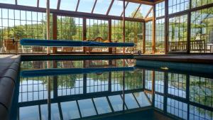 a swimming pool with two blue slides in a building at Casa las Vacas in Cervera de Pisuerga