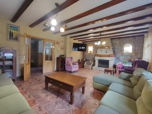 a living room with a couch and a table at Casa las Vacas in Cervera de Pisuerga
