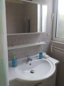 a bathroom with a white sink and a mirror at Rafina suits in Rafina +21 photos