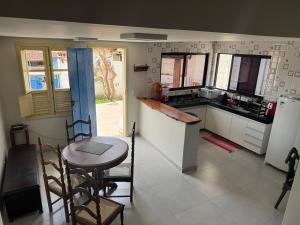 a kitchen with a table and a small table and chairs at Casa Ouro no centro de Diamantina in Diamantina