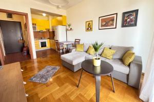 a living room with a couch and a table at Sunny place in Podgorica