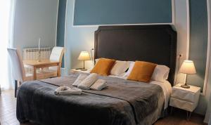 a bedroom with a large bed with two towels on it at Hotel magnolia 1000 mt dal casello in Valmontone