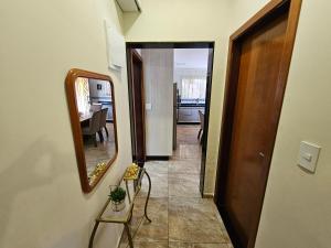a hallway with a mirror and a dining room at Recanto Margarida in Socorro