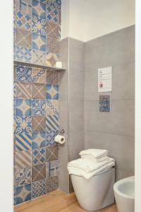 a bathroom with a toilet and a sink at NA bella vista Rooftop-B&B in Naples +73 photos
