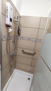 a shower in a bathroom with a hand dryer at Modern 1-Bedroom Ground floor Apartment in Strovolos in Kato Lakatamia