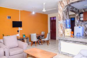 a living room with a fireplace and a dining room at Lifestyle 3 Shanzu 2 bedroom furnished Apartment in Mombasa