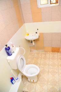 a bathroom with a toilet and a sink at Lifestyle 3 Shanzu 2 bedroom furnished Apartment in Mombasa