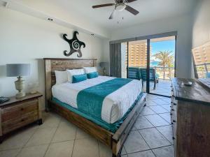 a bedroom with a large bed and a balcony at 3BR Condo at Iconic Sandy Beach Area in Puerto Peñasco +132 photos