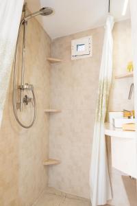 a shower with a shower curtain in a bathroom at Il Violino - a lovely terrace in the centre in Martina Franca