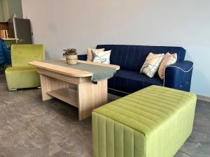 a living room with a couch and a table and a stool at Verde Suite in Varna City