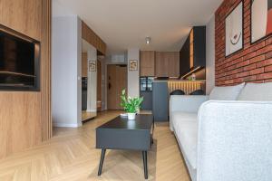 a living room with a couch and a table at River Side Residence in Oświęcim