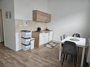 ブレーメンにあるNeustadt Apartmentsの小さなキッチン(テーブル、テーブル、椅子付)