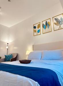 a bedroom with a bed with a blue blanket at Micasa at Green 2 Residences in Dasmariñas +16 photos