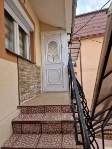a white door on the side of a house at Kalinka Apartment in Bitola