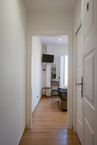 a hallway leading to a bedroom with a bed and a door at NA bella vista Rooftop-B&B in Naples