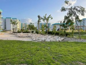 a pile of rocks in a park with buildings at A 7 min del Downtown Punta Cana in Punta Cana