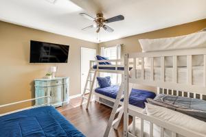 a bedroom with two bunk beds and a ceiling fan at 2 Mi to Gulfport Beaches Poolside Paradise! in Gulfport