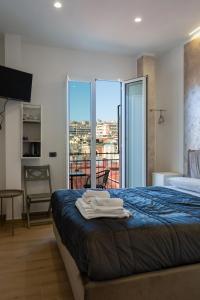 a hotel room with a bed with towels on it at NA bella vista Rooftop-B&B in Naples