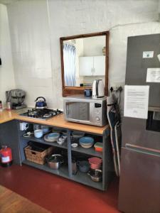 a kitchen with a counter with a microwave and a refrigerator at Ocean rush turtle in Zinkwazi Beach +7 photos