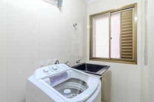 a bathroom with a sink and a washing machine at Apto completo 2Q a Beira-mar ESE0102 in Balneário Camboriú +25 photos