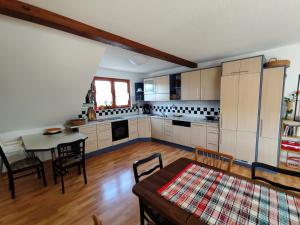 a kitchen with a table and a dining room at Große, gemütliche Wohnung in dörflicher Idylle in Breitenbach am Herzberg