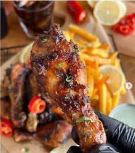 a plate of food with a piece of meat and fries at too house in Al Mughayyir +11 photos