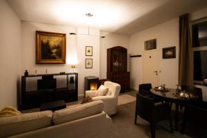 a living room with a couch and a tv at City 60 in Verviers +5 photos