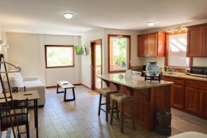a kitchen with wooden cabinets and a counter top at Cottage 5 at Island Pearl Gold Standard Certified in Caye Caulker