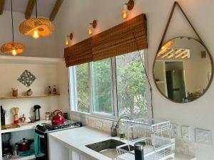 a kitchen with a sink and a mirror at Samaya Corumbau in Corumbau