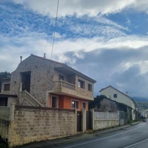 a house on the side of a street at Apartamento Boa Playa in Noya