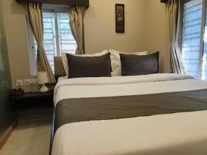 Postel nebo postele na pokoji v ubytování Hotel Rose Inn