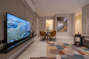 a living room with a large flat screen tv on a wall at شقه 7فاخره ثلاث غرف نوم وجلسه خارجيه in Riyadh