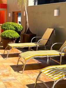 a group of yellow chairs sitting on a patio at Hotel Verdes Mares in Ouro Branco