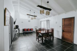 a dining room with a table and chairs and a couch at Cabañas Altos del Volcán in Villarrica
