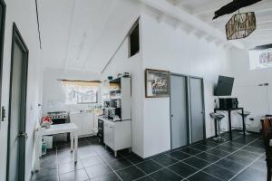 a kitchen with white cabinets and a table and a sink at Cabañas Altos del Volcán in Villarrica