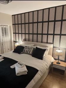 a bedroom with a large bed with a large headboard at The Mayfair Lodge & Family Suite in Hartlepool