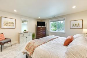 a bedroom with a bed and a tv and a chair at 2 Mi to State Fair Puyallup Home with Private Yard! in Puyallup