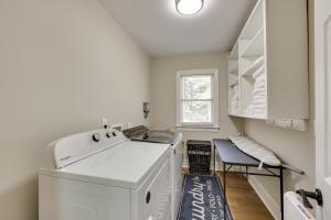 a laundry room with a washing machine and a chair at Less Than 2 Mi to ECU Cozy Greenville Getaway for Fall in Greenville +20 photos