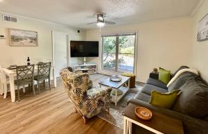 a living room with a couch and a table at Cozy 1BD, 5 Mins Walk to the Beach, No Stairs! in Hilton Head Island