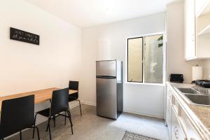 a kitchen with a refrigerator and a table and chairs at Second-Floor 1-BR Near Beverly Hills and Top Los Angeles Attractions in Los Angeles +7 photos