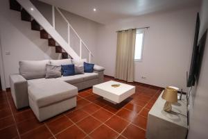 a living room with a couch and a table at Casa do Parque in Rabo de Peixe