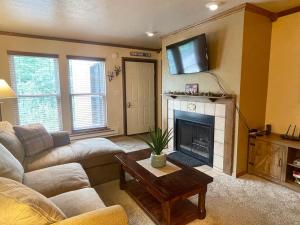 a living room with a couch and a fireplace at Snowed Inn in Brian Head
