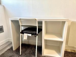 a white desk with a chair under it at Large Double Room in Cardiff City Centre, Room Only with Own Bathroom, HOST LIVES ON SITE in Cardiff