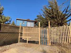 una staccionata di legno davanti a una casa di Tiny cabaña en playa hermosa Pichilemu a Pichilemu