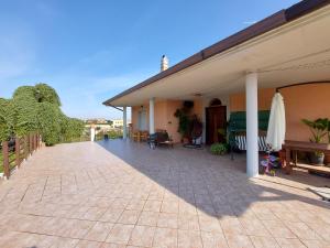 a patio of a building with a table and umbrella at Villa Marusia in Tollo +44 photos