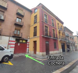 a white car parked in front of a building at San Miguel Estudio in Palencia