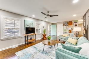 a living room with a couch and a tv at Family Friendly Chic Retreat in Rocky Mount! in Rocky Mount