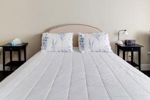 a bed with blue and white sheets and pillows at Sisters Retreat Upper Lower in Sisters +18 photos