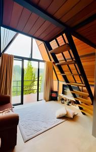 a large room with a bed and large windows at Pousada Casa Florinda in Teresópolis +49 photos